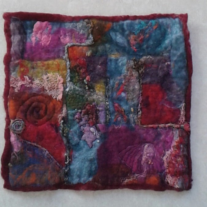 A wet felted abstract picture.