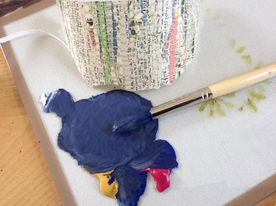 Acrylic paint is mixed to compliment the blue seen in the Newsprint wallpaper.