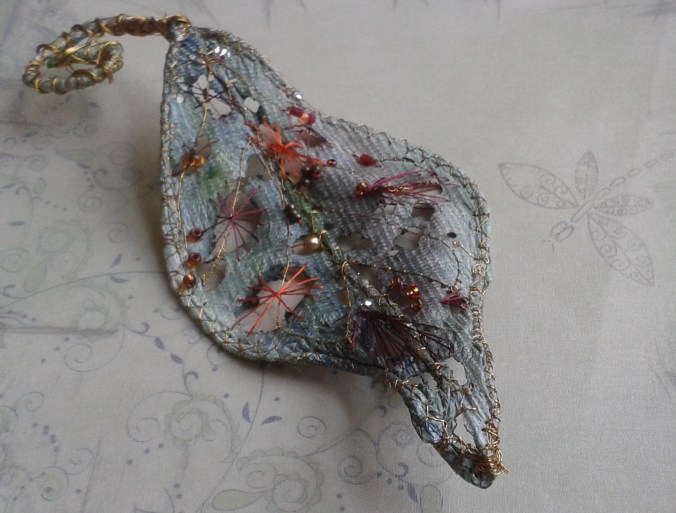 My blue/green handmade leaf stitched with metallic thread and embellished with tiny coloured beads.
