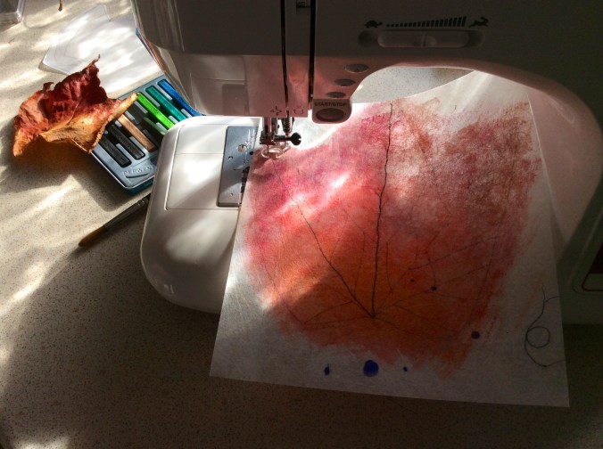 A photograph showing my painted leaf having the veins sewn on using my Janome sewing machine