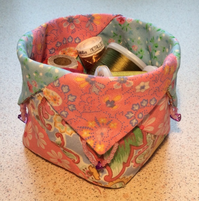 Small square shaped container made from four different patterned fabrics