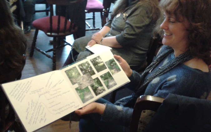 An open sketchbook showing photographs of the countryside on the right and hand written notes on the left.