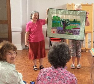 Molly proudly shows off her quilt at the show and tell session.