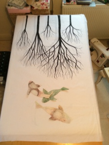 The first stage of the art quilt A Tribute to Three Worlds....trees and fish are painted and in position.