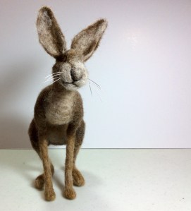 Needle felted brown hare looking towards the viewer